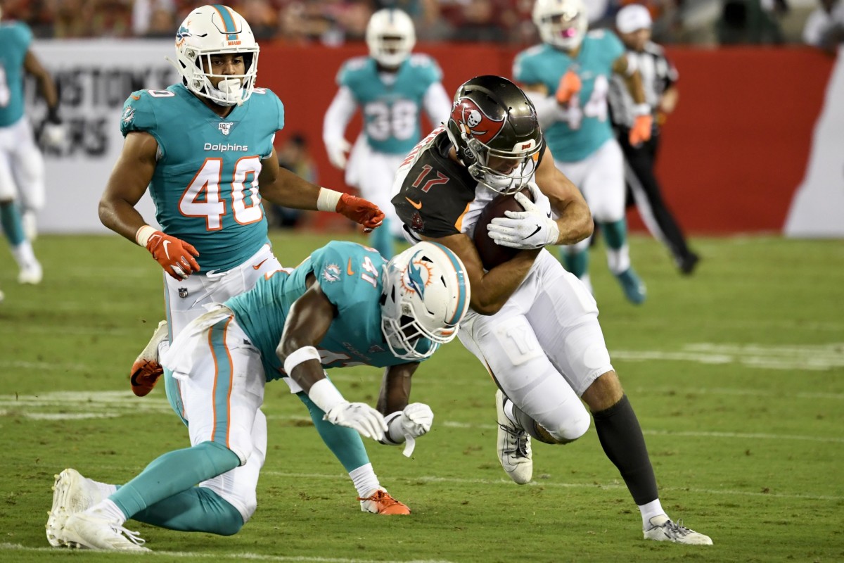Tampa Bay Buccaneers wide receiver Justin Watson (17) runs with the ball as Miami Dolphins defensive back Montre Hartage (41) defends during the fourth quarter at Raymond James Stadium.