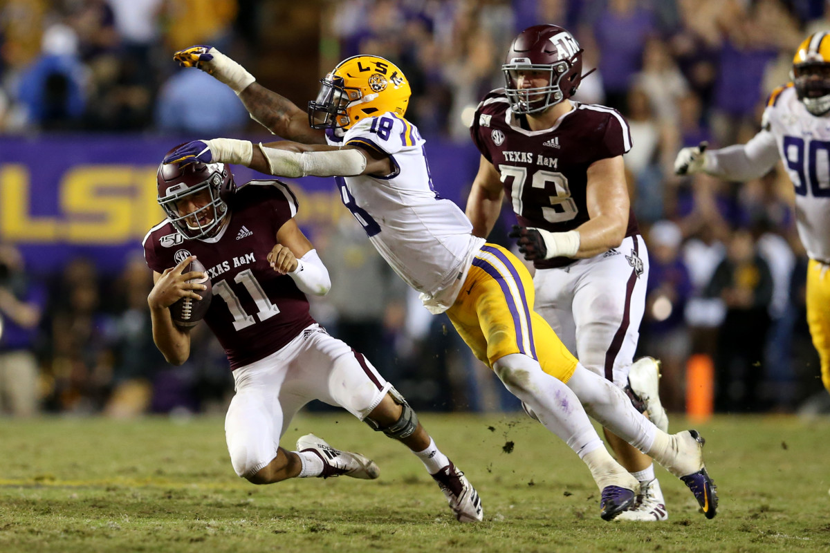 Nov 30, 2019; Baton Rouge, LA, USA; Texas A&M Aggies quarterback Kellen Mond (11) is tackled by LSU Tigers linebacker K'Lavon Chaisson (18) in the second half at Tiger Stadium. Mandatory Credit: Chuck Cook-USA TODAY Sports