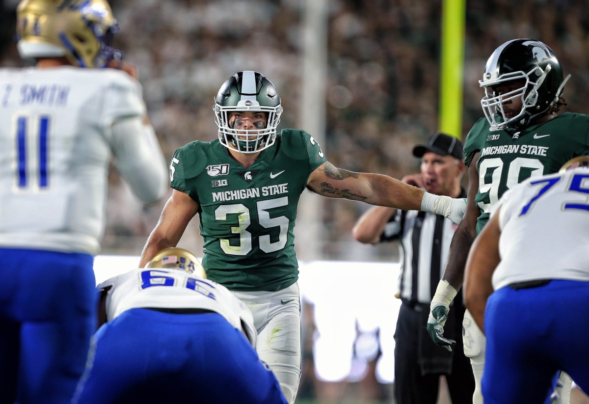 Aug 30, 2019; East Lansing, MI, USA; Michigan State Spartans linebacker Joe Bachie (35) gestures to Michigan State Spartans defensive tackle Raequan Williams (99) during the second half of a game at Spartan Stadium. Mandatory Credit: Mike Carter-USA TODAY Sports