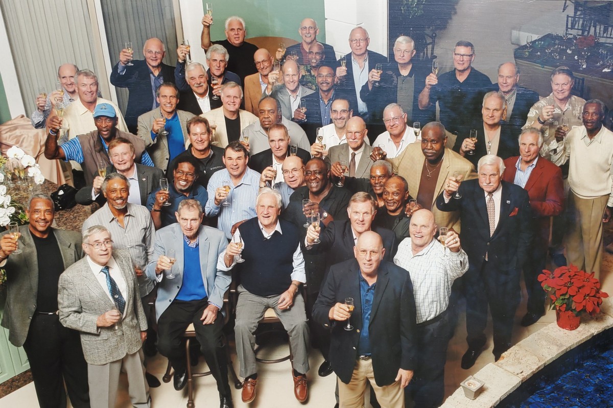 Don Shula (front row, center) and players from his 1972 undefeated Miami Dolphins team raise a glass to toast their success during a 40th anniversary party at Shula's house on Dec. 13, 2012. (Photo courtesy of Doug Crusan)