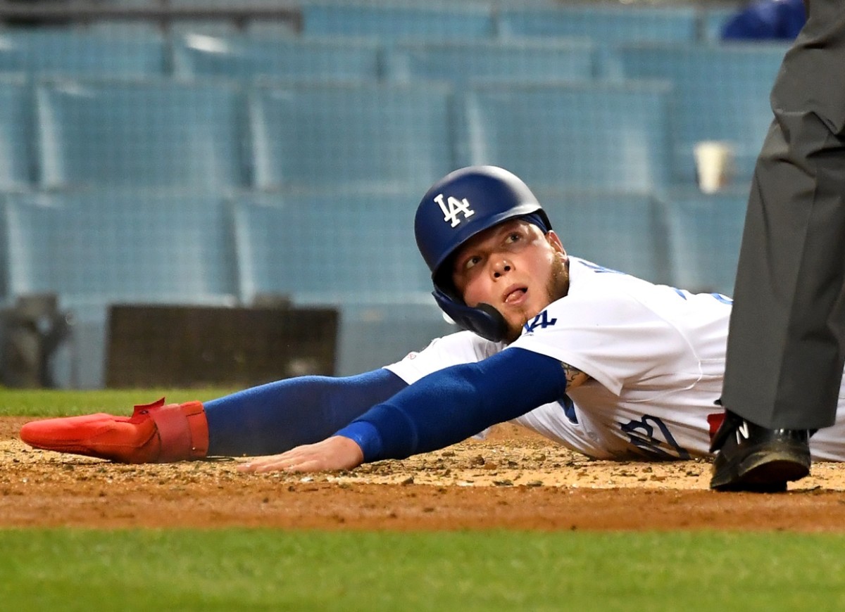 May 7, 2019; Los Angeles, CA, USA; Los Angeles Dodgers center fielder Alex Verdugo (27) looks for the call as he beats the throw to Atlanta Braves catcher Tyler Flowers (25) to score a run in the second inning of the game at Dodger Stadium. Mandatory Credit: Jayne Kamin-Oncea-USA TODAY Sports