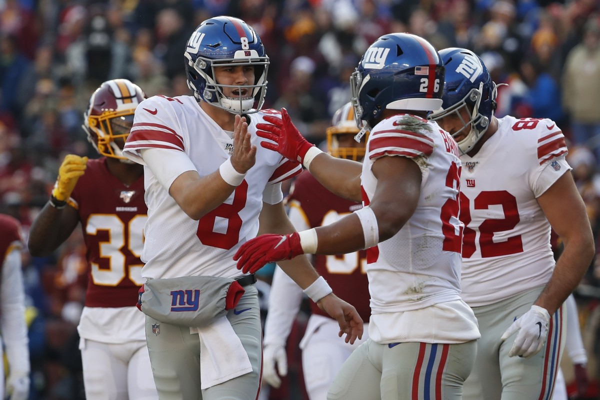 Dec 22, 2019; Landover, Maryland, USA; New York Giants quarterback Daniel Jones (8) celebrates with Giants running back Saquon Barkley (26) after connecting on a touchdown pass against the Washington Redskins in the second quarter at FedExField.