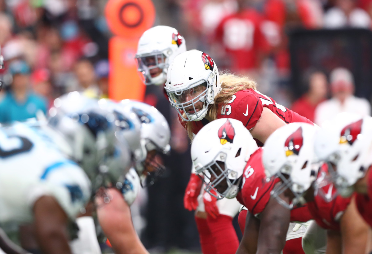 Cardinals linebacker Brooks Reed eyes the Panthers' offensive line during a 2019 game. The Cardinals and Panthers have become rivals after facing off three times in the playoffs since 2008.
