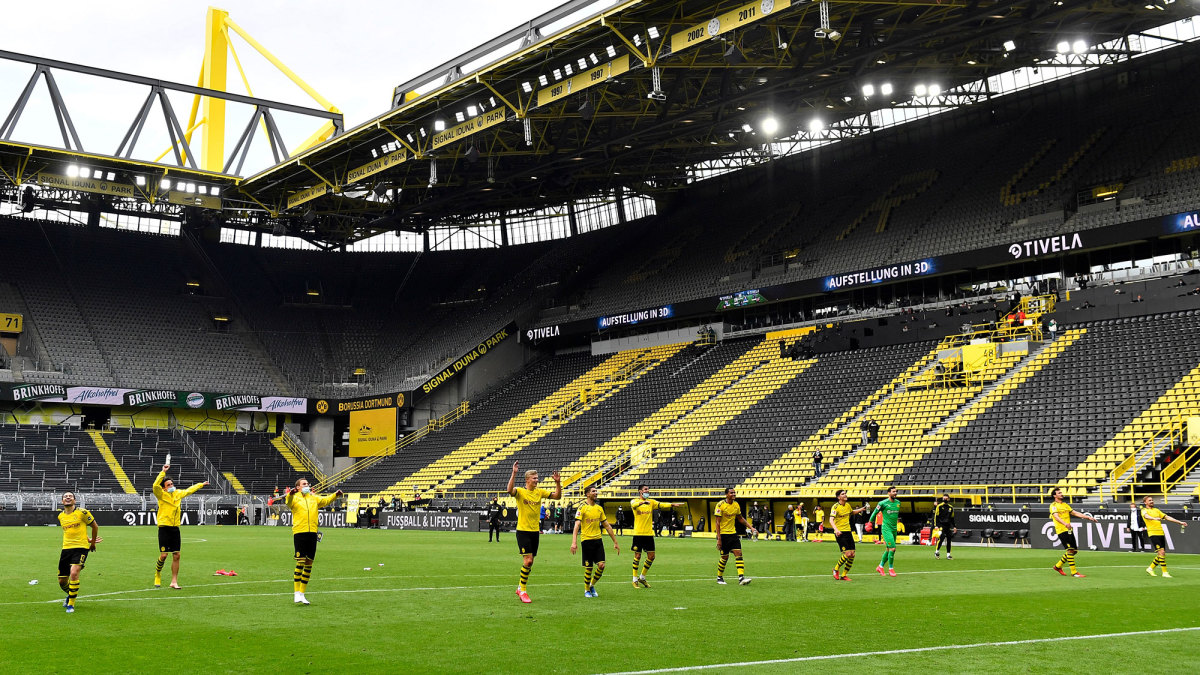 Dortmund players salute the empty Yellow Wall at Signal Iduna Park