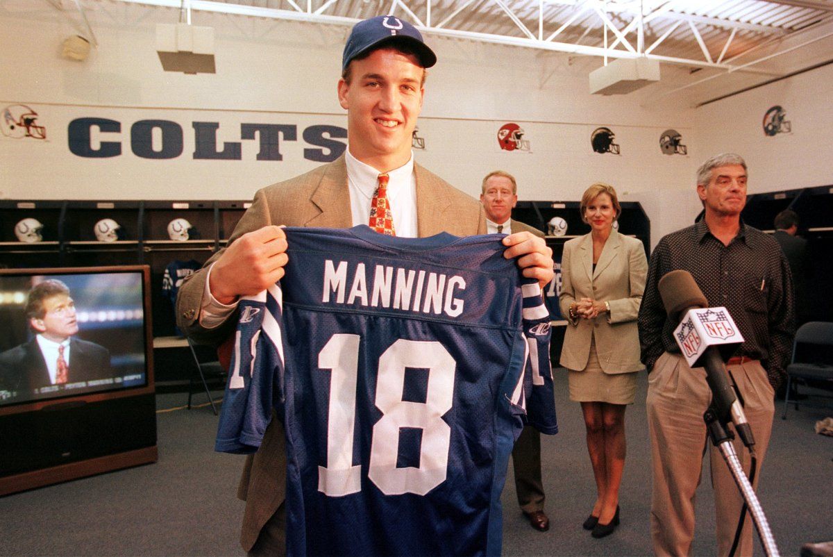 Peyton Manning holds up his No. 18 Indianapolis Colts jersey after being selected No. 1 overall in the 1998 NFL draft.
