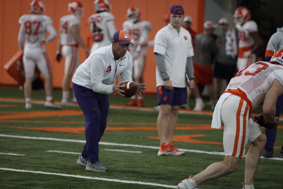 Clemson coach Dabo Swinney runs a drill with the receivers at a spring practice earlier this year.