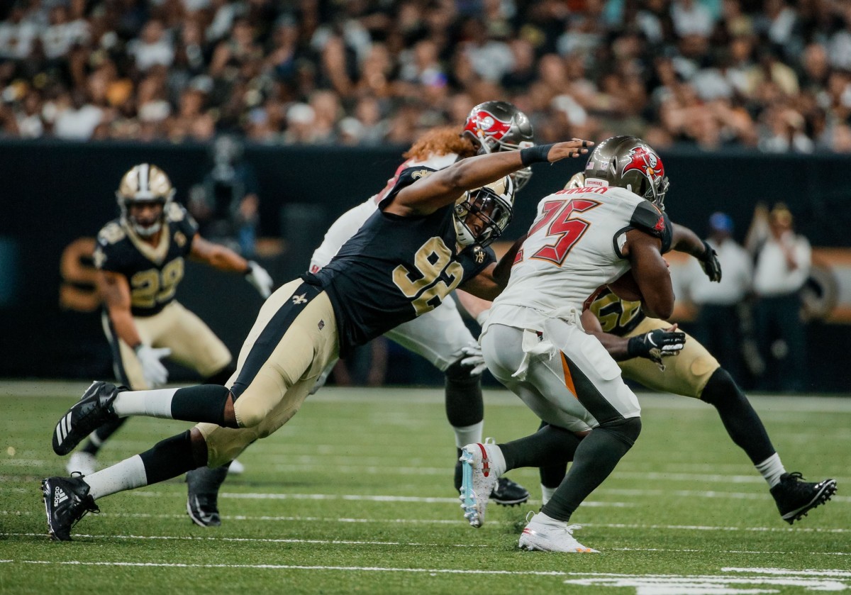 Sep 9, 2018; New Orleans, LA, USA; New Orleans Saints defensive end Marcus Davenport (92) tackles Tampa Bay Buccaneers running back Peyton Barber (25) during the second half of a game at the Mercedes-Benz Superdome. The Buccaneers defeated the Saints 48-40. Mandatory Credit: Derick E. Hingle-USA TODAY Sports