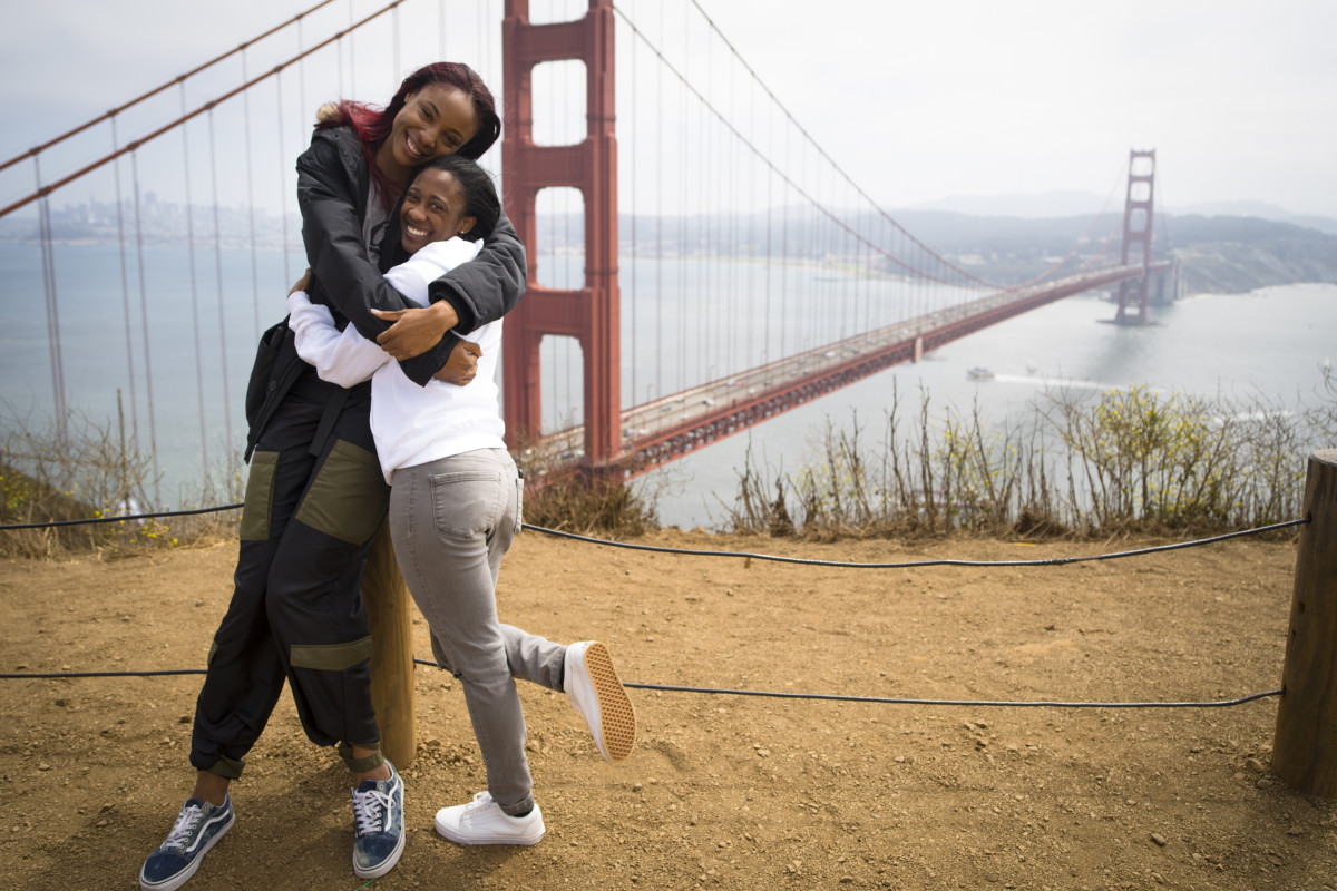Kristine Anigwe, left, embraces teammate Asha Thomas in front of the Golden Gate Bridge