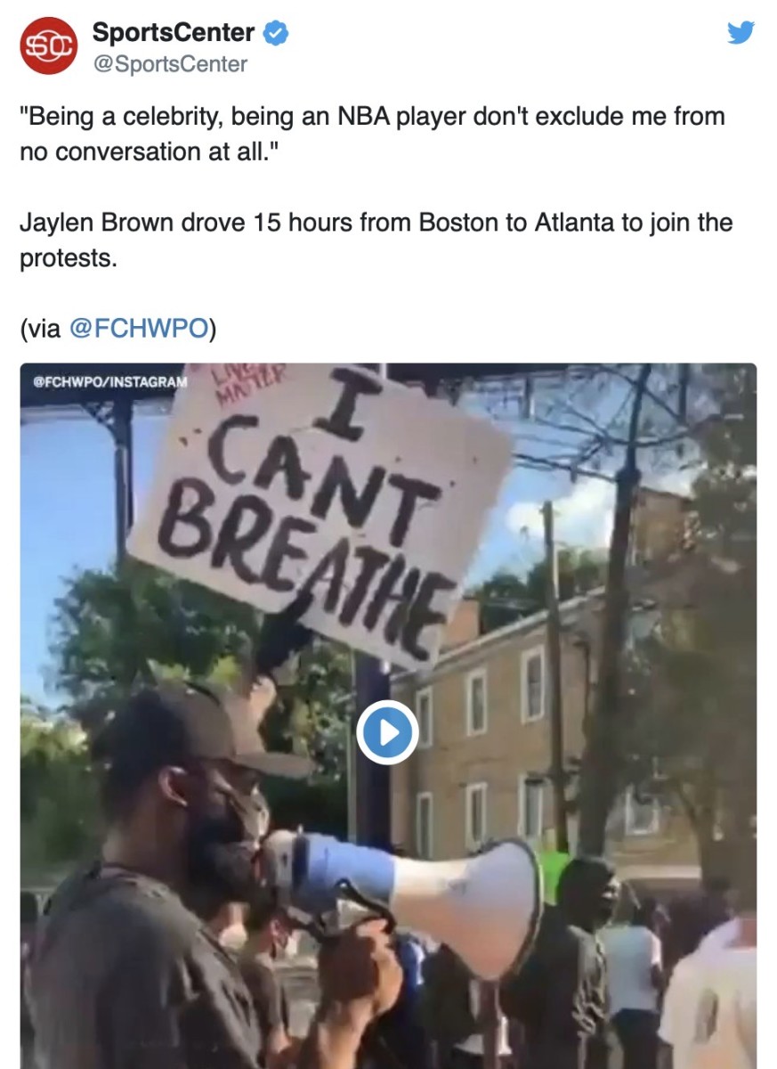Jaylen Brown, equipped with a megaphone, helps lead a protest march in Atlanta