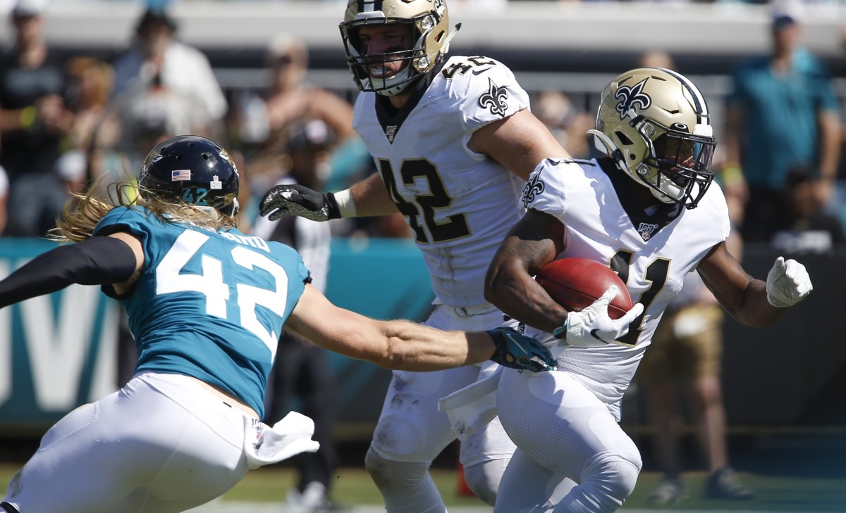 Oct 13, 2019; Jacksonville, FL, USA; New Orleans Saints wide receiver Deonte Harris (11) runs against Jacksonville Jaguars defensive back Andrew Wingard (left) as Saints fullback Zach Line (top) looks on during the second quarter at TIAA Bank Field. Mandatory Credit: Reinhold Matay-USA TODAY Sports