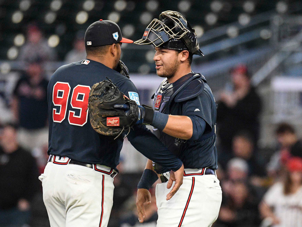 Catcher Alex Jackson puts his arm around another Braves pitcher.