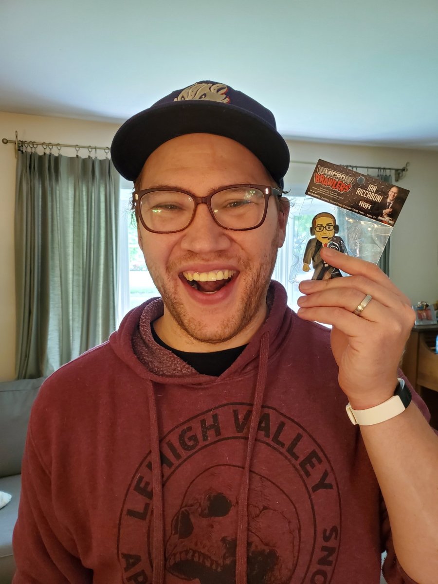 ROH's Ian Riccaboni holds up his LGBT awareness wrestling figurine