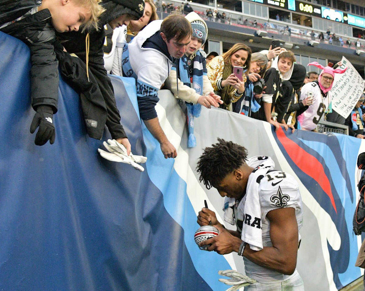 Dec 22, 2019; Nashville, Tennessee, USA; New Orleans Saints wide receiver Michael Thomas (13) signs autographs for fans following his teams 38-28 victory over the Tennessee Titans at Nissan Stadium. Mandatory Credit: Jim Brown