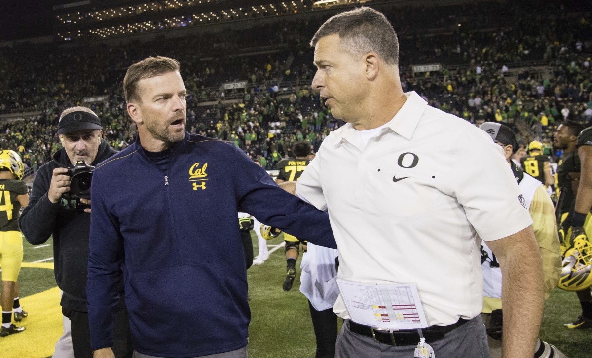 Cal's Justin Wilcox, left, and Oregon's Mario Cristobal meet after their game