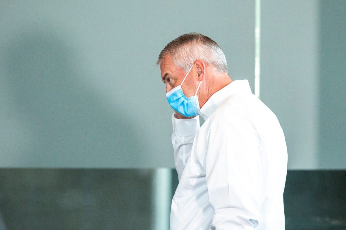 Iowa athletics director Gary Barta begins to remove his mask before Monday's press conference. (Joseph Cress/Iowa City Press-Citizen for USA Today Sports)