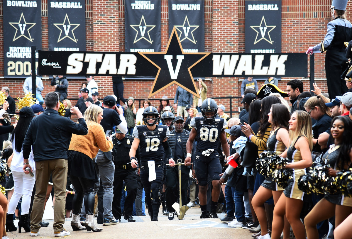 Vanderbilt Commodores head coach Derek Mason walks behind Vanderbilt quarterback Mo Hasan (18) and Vanderbilt Commodores tight end Jared Pinkney (80) during Star Walk before the game against the Missouri Tigers at Vanderbilt Stadium.