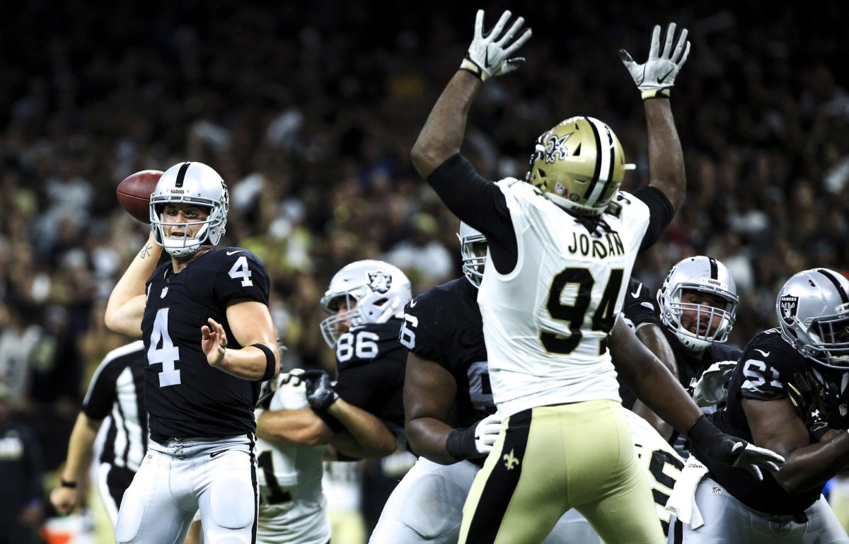 Sep 11, 2016; New Orleans, LA, USA; Oakland Raiders quarterback Derek Carr (4) is pressured by New Orleans Saints defensive end Cameron Jordan (94) during the fourth quarter of a game at the Mercedes-Benz Superdome. The Raiders defeated the Saints 35-34. Mandatory Credit: Derick E. Hingle-USA TODAY Sports