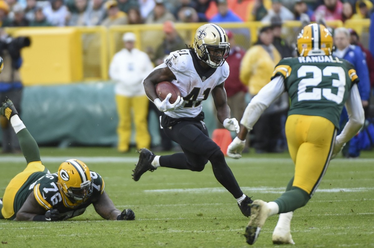 Oct 22, 2017; Green Bay, WI, USA; New Orleans Saints running back Alvin Kamara (41) rushes past Green Bay Packers defensive tackle Mike Daniels (76) and cornerback Damarious Randall (23) in the fourth quarter at Lambeau Field. Mandatory Credit: Benny Sieu-USA TODAY Sports