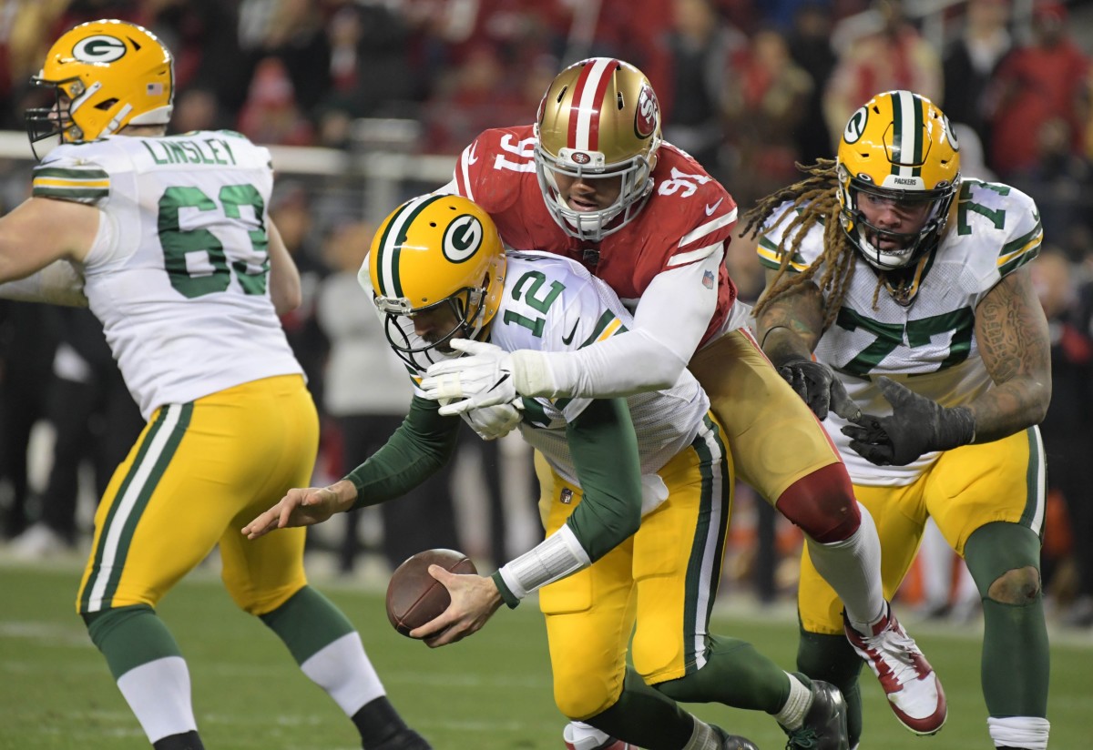 Jan 19, 2020; Santa Clara, California, USA; Green Bay Packers quarterback Aaron Rodgers (12) is sacked by San Francisco 49ers defensive end Arik Armstead (91) in the fourth quarter of the NFC Championship Game at Levi's Stadium. Mandatory Credit: Kirby Lee-USA TODAY Sports