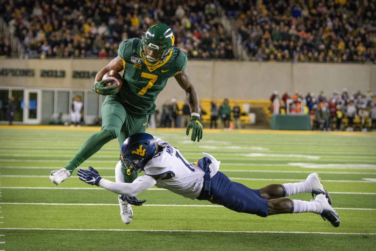 Baylor Bears running back John Lovett (7) tries to leap West Virginia Mountaineers safety Kerry Martin Jr. (15) during the second quarter at McLane Stadium.