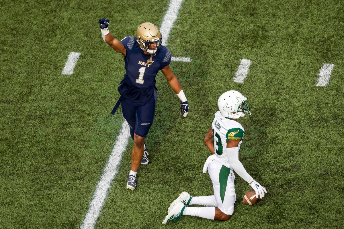 Navy Midshipmen linebacker Jacob Springer (1) reacts after a play against South Florida Bulls wide receiver Eddie McDoom (13) during the first half at Navy-Marine Corps Memorial Stadium. (Scott Taetsch-USA TODAY Sports)