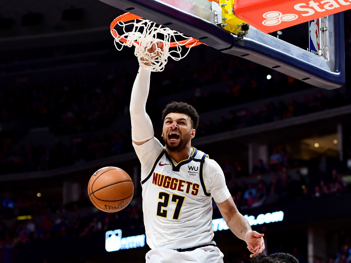 Mar 9, 2020; Denver, Colorado, USA; Denver Nuggets guard Jamal Murray (27) finishes off a basket over Milwaukee Bucks forward D.J. Wilson (5) in the third quarter at the Pepsi Center.