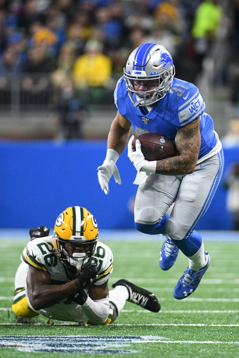 Dec 29, 2019; Detroit, Michigan, USA; Detroit Lions running back Ty Johnson (31) carries the ball as Green Bay Packers free safety Darnell Savage (26) defends during the first quarter at Ford Field. Mandatory Credit: Tim Fuller-USA TODAY Sports