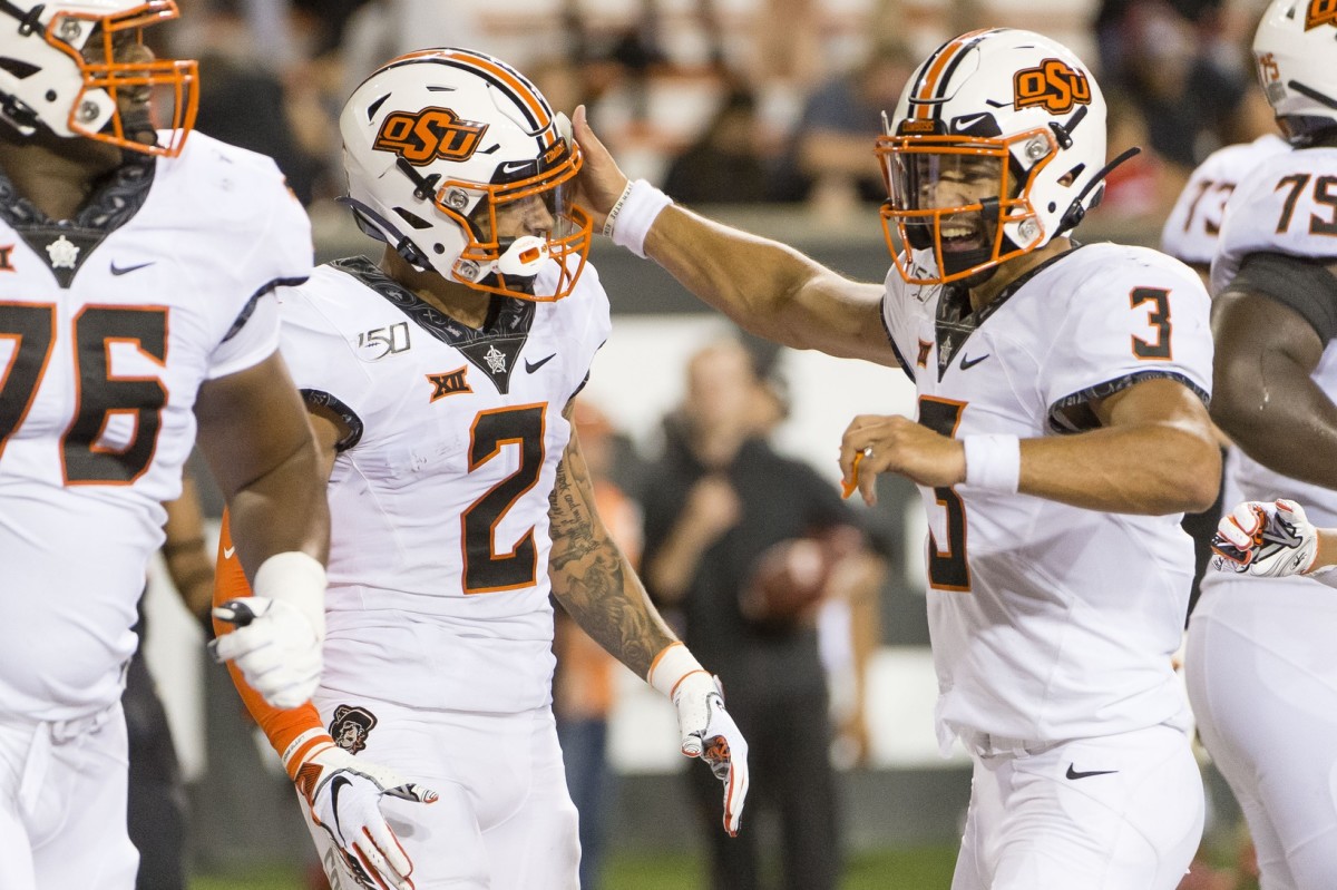 Galloway (76) celebrating a score with Spencer Sanders (3) and Tylan Wallace (2) at Oregon State.