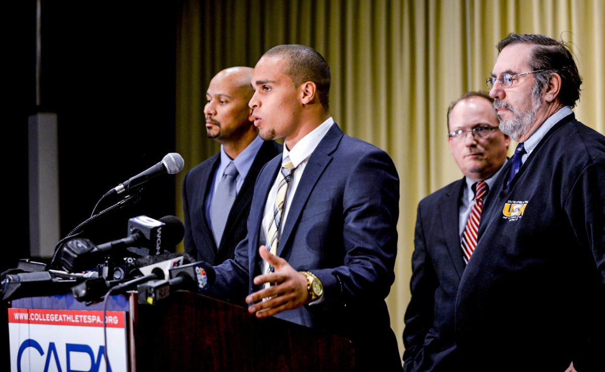 Colter (at mic) with Huma in January 2014, before the NLRB declined jurisdiction on Northwestern's unionization bid.