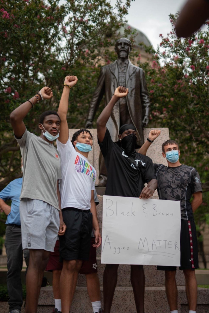 Infinite Tucker and other Texas A&M students protest in front of the Lawrence Sullivan Ross statue on campus.