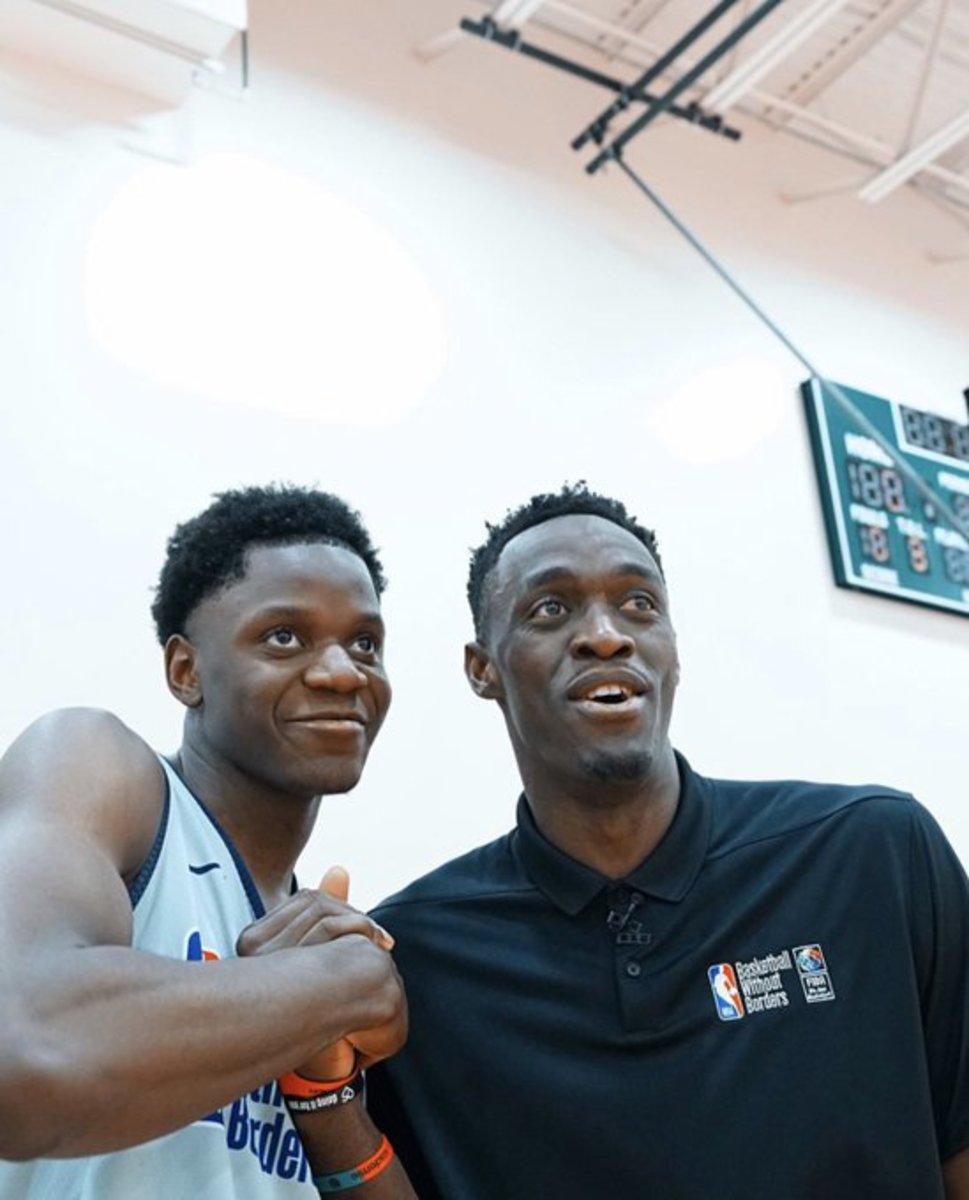 Alex Tchikou (left) posing for a photo with Toronto Raptors star player Pascal Siakam during the NBA's 'Basketball Without Borders' event in Chicago during the league's all-star weekend. 