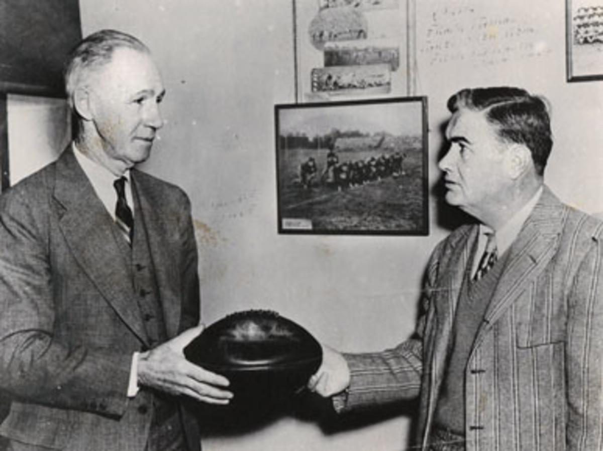 Wallace Wade hands a ball to his successor, Frank Thomas
