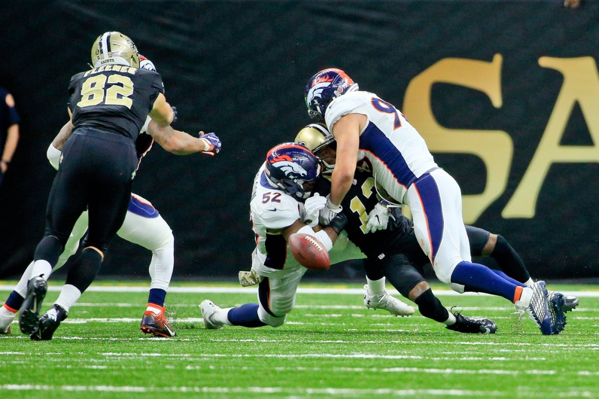 Nov 13, 2016; New Orleans, LA, USA; Denver Broncos inside linebacker Corey Nelson (52) and defensive end Jared Crick (93) force a fumble by New Orleans Saints wide receiver Michael Thomas (13) during the fourth quarter of a game at the Mercedes-Benz Superdome. The Broncos defeated the Saints 25-23. Mandatory Credit: Derick E. Hingle-USA TODAY Sports