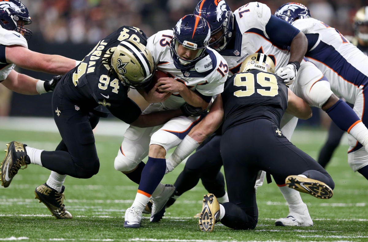 Nov 13, 2016; New Orleans, LA, USA; Denver Broncos quarterback Trevor Siemian (13) is sacked by New Orleans Saints defensive ends Cameron Jordan (94) and Paul Kruger (99) in the first half at the Mercedes-Benz Superdome. Mandatory Credit: Chuck Cook-USA TODAY Sports