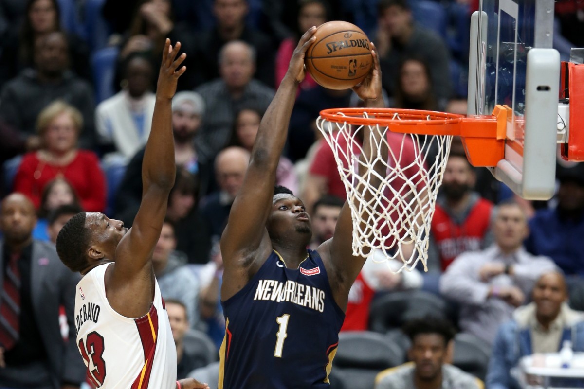 Mar 6, 2020; New Orleans, Louisiana, USA; New Orleans Pelicans forward Zion Williamson (1) dunks against Miami Heat forward Bam Adebayo (13) in the second half at the Smoothie King Center. Mandatory Credit: Chuck Cook