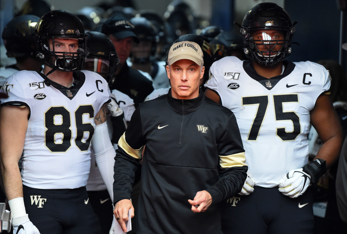 Wake Forest Demon Deacons head coach Dave Clawson stands with tight end Jack Freudenthal (86) and offensive lineman Justin Herron (75) prior to taking the field for the game against the Syracuse Orange at the Carrier Dome
