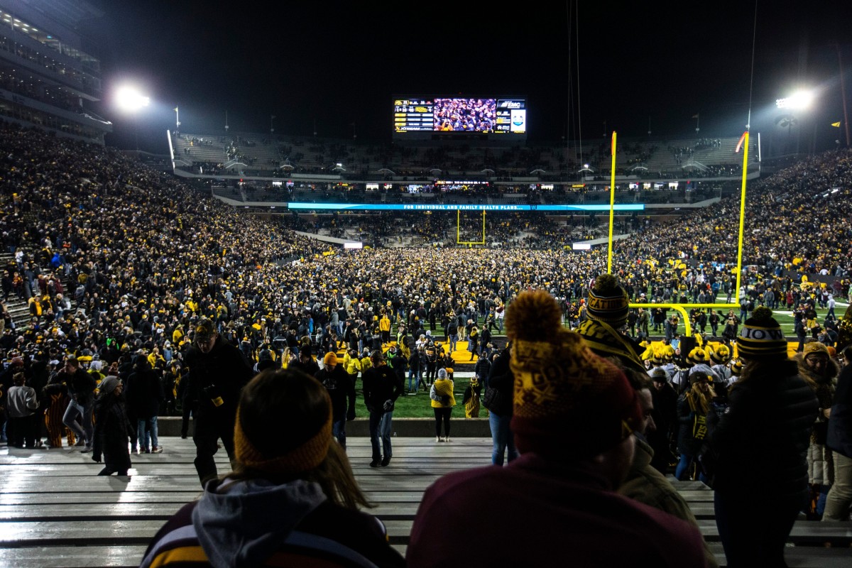 Minnesota fans sit in the stands as Iowa fans swarm the field after the Hawkeyes defeated the previously-unbeaten Gophers last November at Kinnick Stadium. (Joseph Cress/Iowa City Press-Citizen for USA Today Sports)