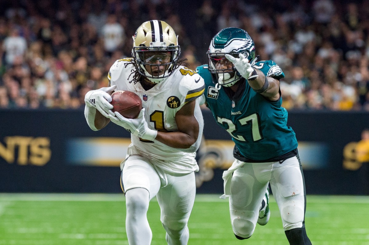 RB Alvin Kamara evades S Malcolm Jenkins for a touchdown.
