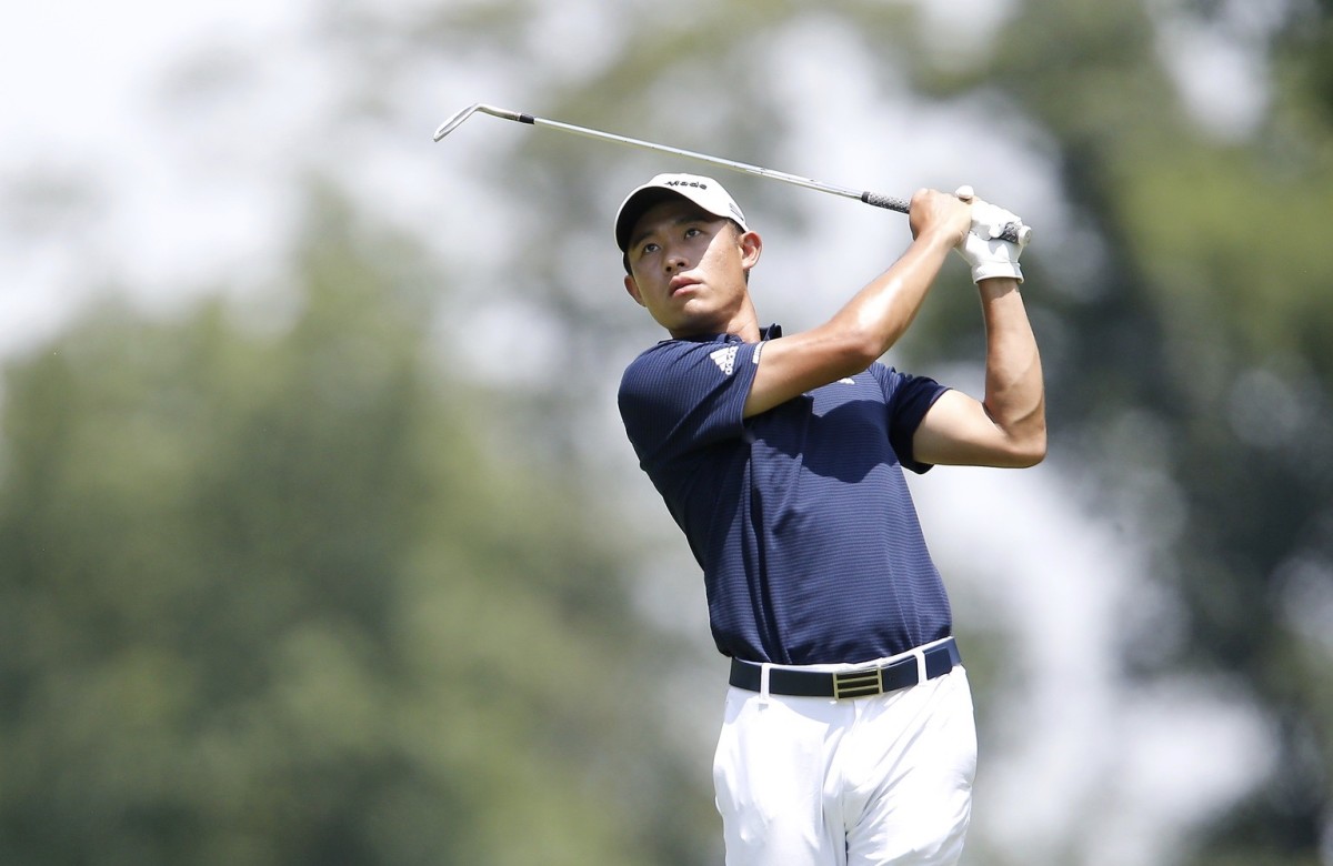 Collin Morikawa watches his iron shot during Friday's second round