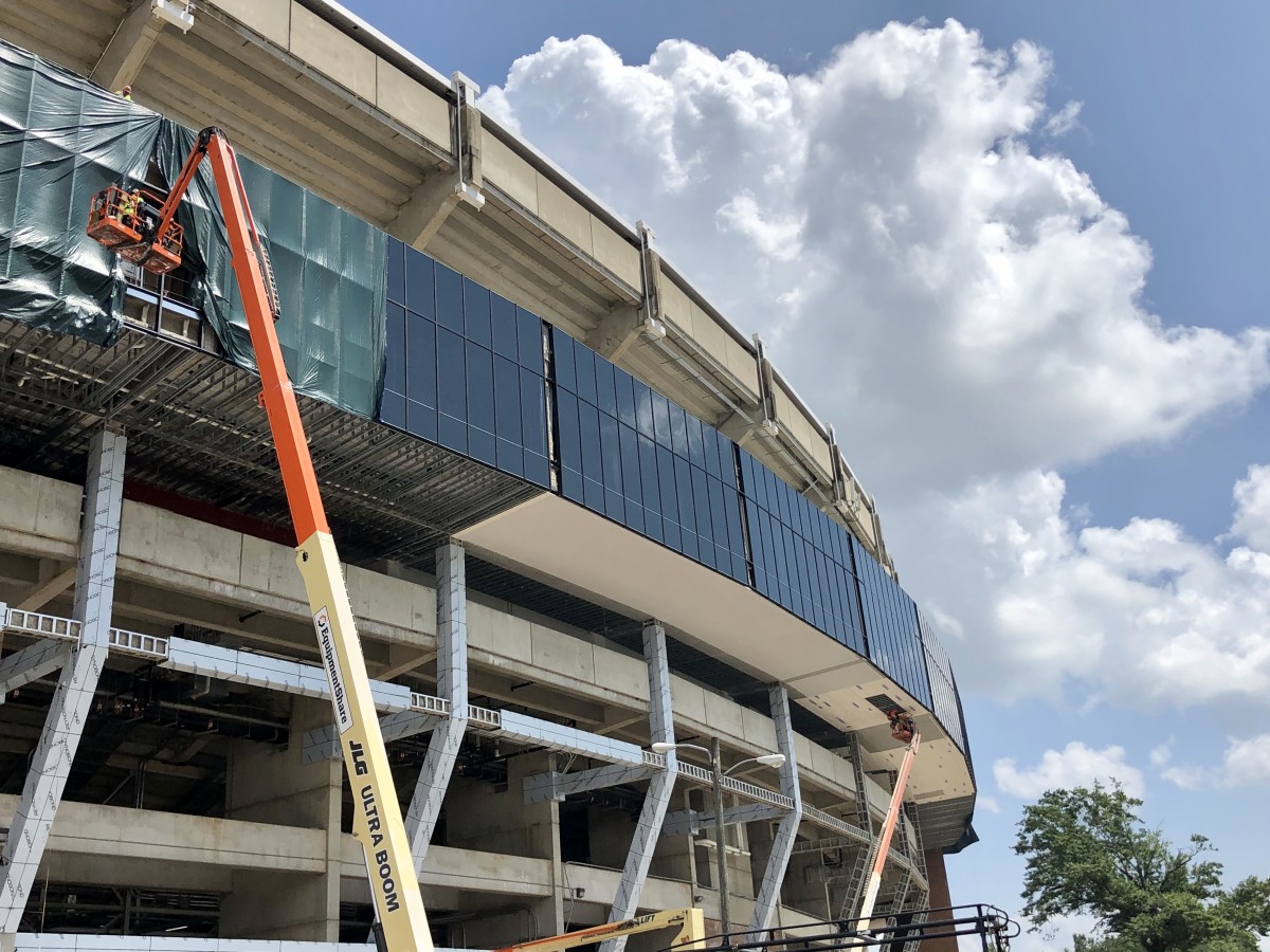 Workers insert glass along the outer rim of Bryant-Denny Stadium, July 10, 2020