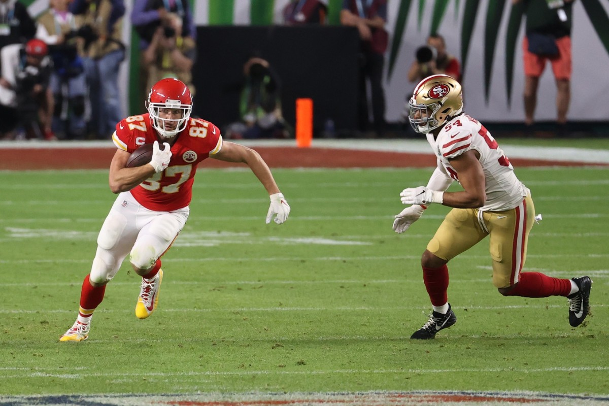 Feb 2, 2020; Miami Gardens, Florida, USA; Kansas City Chiefs tight end Travis Kelce (87) carries the ball as San Francisco 49ers middle linebacker Fred Warner (54) chases in Super Bowl LIV at Hard Rock Stadium. Mandatory Credit: Geoff Burke-USA TODAY Sports