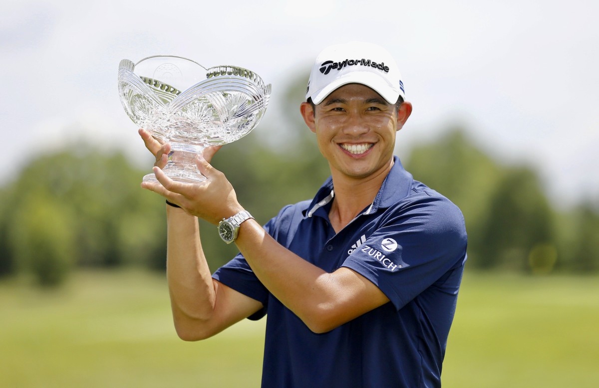 Collin Morikawa shows off his championship trophy