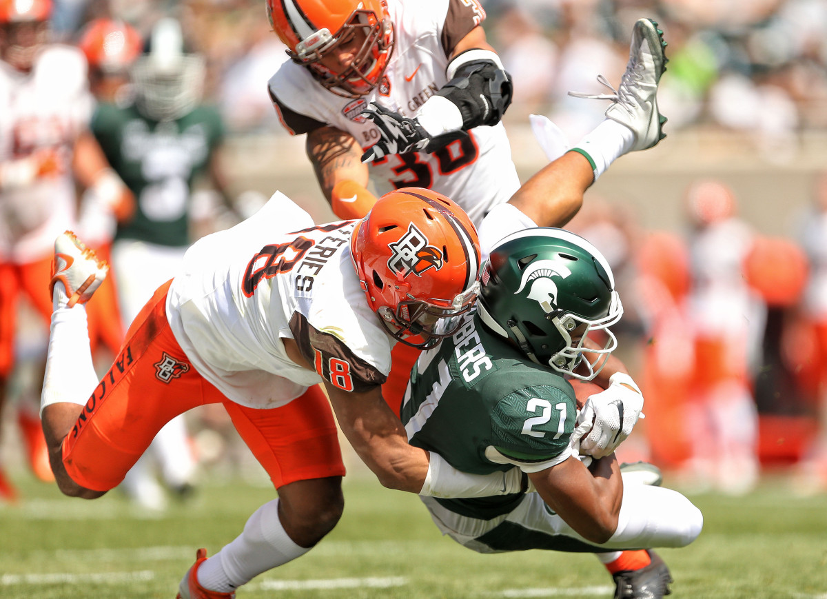Michigan State Spartans wide receiver Cam Chambers (21) is tackled by Bowling Green Falcons defensive back Cameron Jefferies (18) during the second half of a 2017 game at Spartan Stadium.