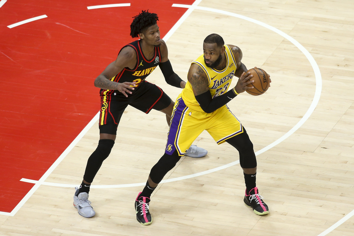 Atlanta Hawks guard Cam Reddish (22) defends Los Angeles Lakers forward LeBron James (23) in the fourth quarter at State Farm Arena.