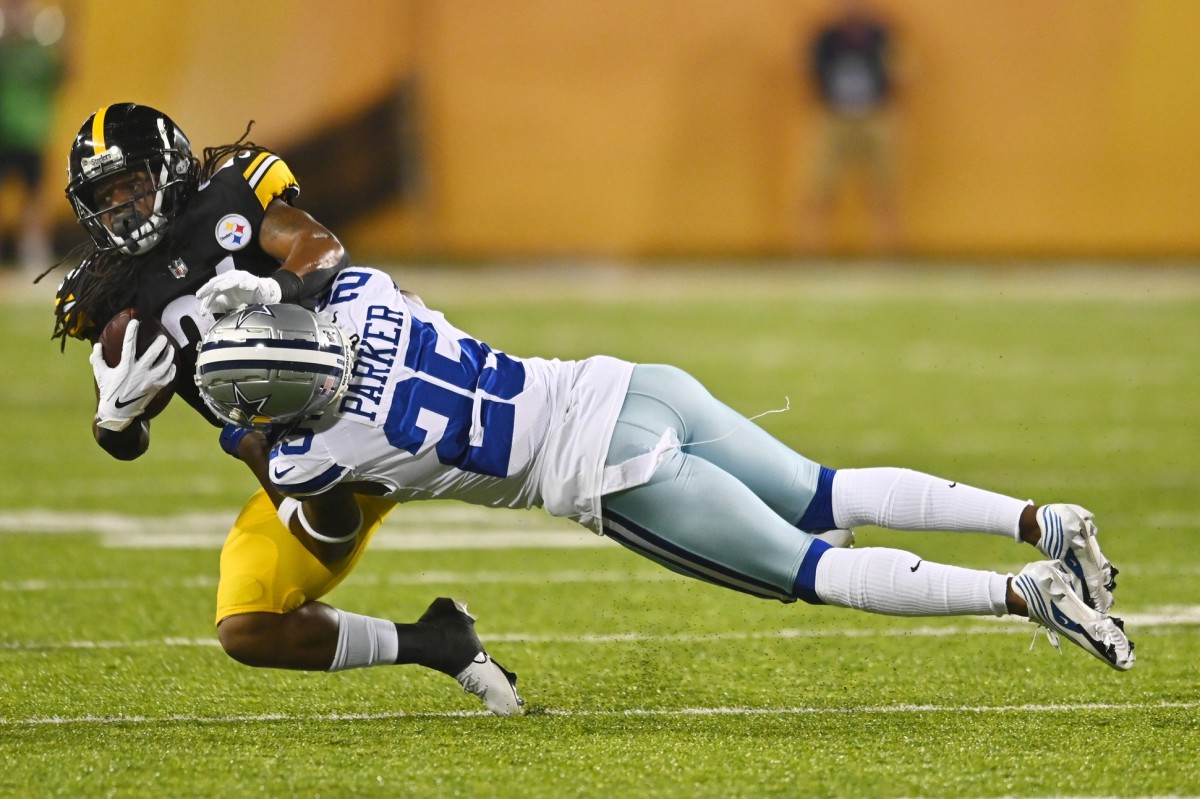 Aug 5, 2021; Canton, Ohio, USA; Dallas Cowboys defensive back Steven Parker (25) tackles Pittsburgh Steelers running back Anthony McFarland (26) during the second half at Tom Benson Hall of Fame Stadium.