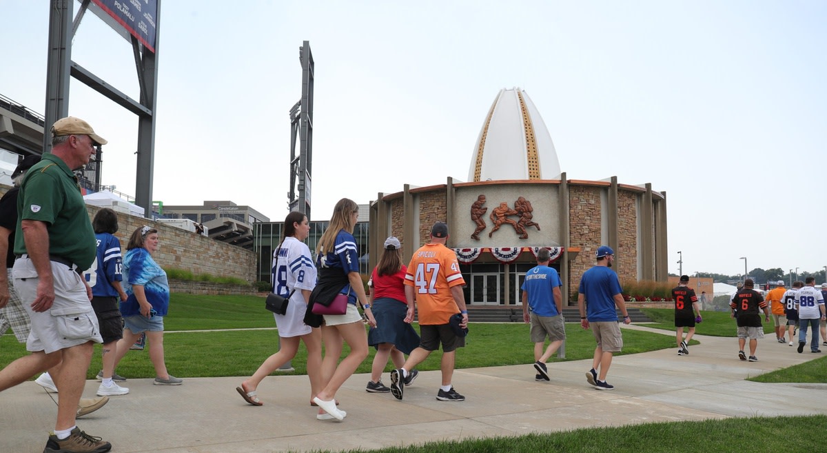 Fans walk to the HOF museum before the Pro Football Hall of Fame Enshrinement ceremony Sunday, Aug. 8, 2021 at Tom Benson Hall of Fame Stadium in Canton, Ohio.