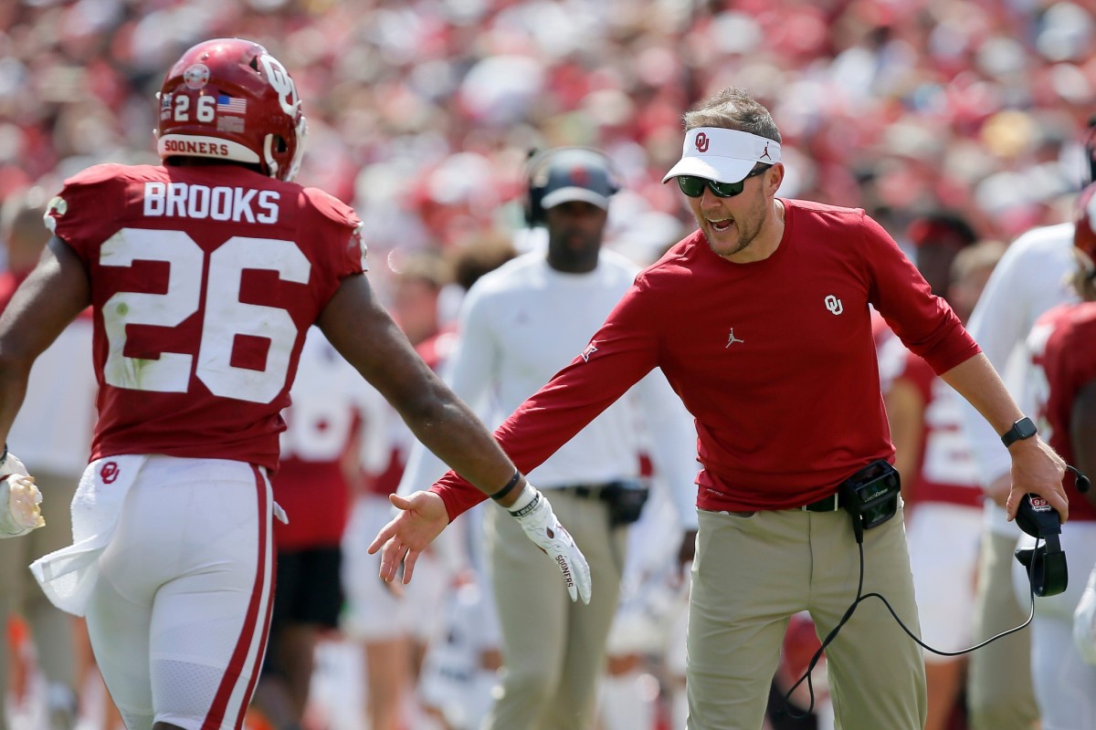Oklahoma coach Lincoln Riley slaps hands with Oklahoma's Kennedy Brooks (26) during a college football game between the University of Oklahoma Sooners (OU) and the Nebraska Cornhuskers at Gaylord Family-Oklahoma Memorial Stadium in Norman, Okla., Saturday, Sept. 18, 2021. Oklahoma won 23-16.