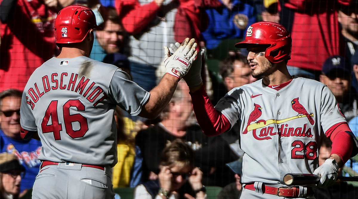 Nolan Arenado greets Cardinals teammate Paul Goldschmidt after the first baseman hit a three-run home run vs. Milwaukee.