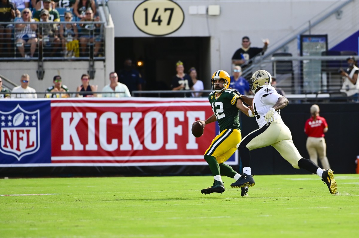 Green Bay Packers quarterback Aaron Rodgers (12) scrambles as New Orleans Saints defensive end Cameron Jordan (94) pressures. Mandatory Credit: Tommy Gilligan-USA TODAY Sports