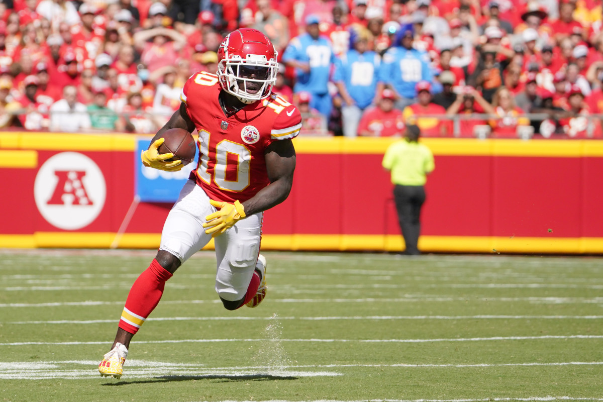Sep 26, 2021; Kansas City, Missouri, USA; Kansas City Chiefs wide receiver Tyreek Hill (10) runs the ball against the Los Angeles Chargers during the first half at GEHA Field at Arrowhead Stadium. Mandatory Credit: Denny Medley-USA TODAY Sports